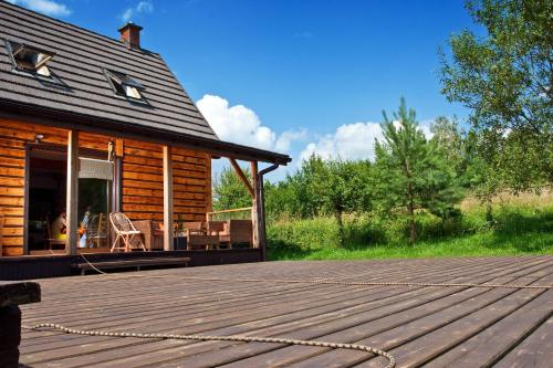 a porch of a log cabin with a patio at Podlesice 38 in Kroczyce