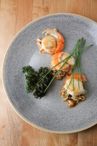 a plate of food with shrimp and broccoli on a table at Battlesteads in Wark