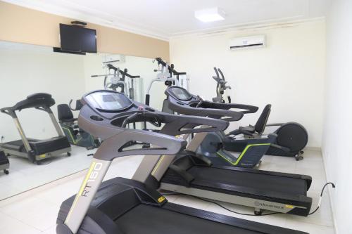 a gym with several tread machines in a room at Larison Executive by Easy Hotéis in Porto Velho