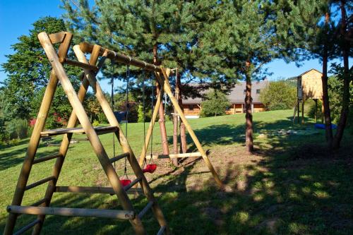 a wooden swing set in a park at Podlesice 38 in Kroczyce