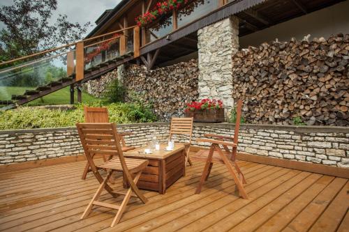 two chairs and a table on a wooden deck at Podlesice 38 in Kroczyce