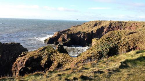a view of the ocean and a rocky coastline at The Old Brewhouse in Arbroath