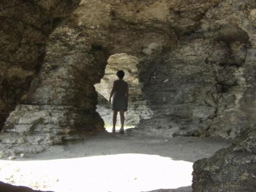 a man standing in a tunnel in a rocky cave at Guest House Orbita in Tyulenovo