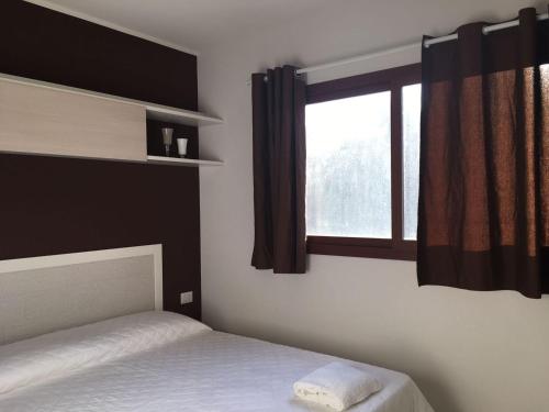 a bedroom with a bed and a window at Giardino Don Berardino in Mattinata
