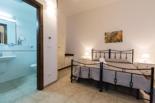 a hotel room with a bed and a shower at Masseria Valente in Ostuni