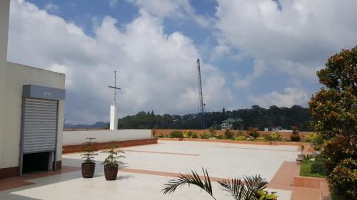 a large courtyard with plants and a building at French Nest at Baguio- Megatower Residences in Baguio