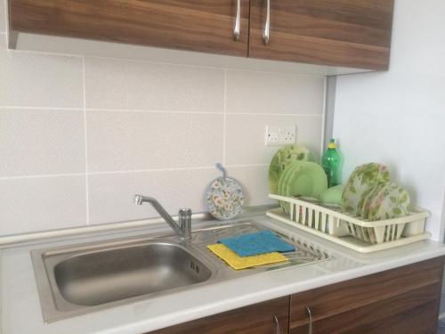 a kitchen counter with a sink and some dishes at Tempo Sea Suits in Kérynia