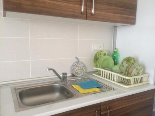 a kitchen counter with a sink and some dishes at Tempo Sea Suits in Kyrenia