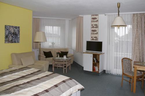 a hotel room with a bed and a living room at Apparthotel am Friedrichspark in Bad Pyrmont