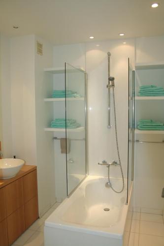 a bathroom with a shower and a bath tub at O' Casino in Ostend