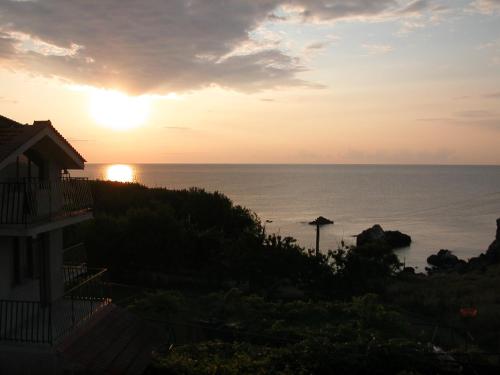 a sunset from the balcony of a house at Guest House Orbita in Tyulenovo