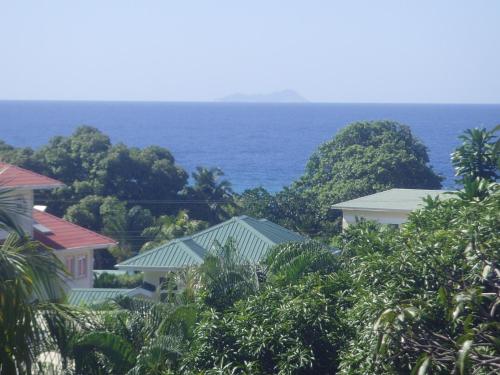 a view of some houses and the ocean at Skyline View in Bel Ombre