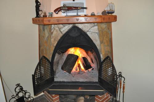 a brick oven with a fire in it at Guest House Orbita in Tyulenovo