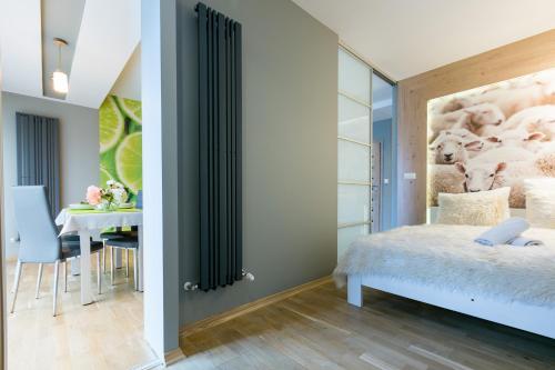 a bedroom with a bed and a dining room with a table at VIP Apartamenty Stara Polana 2 in Zakopane