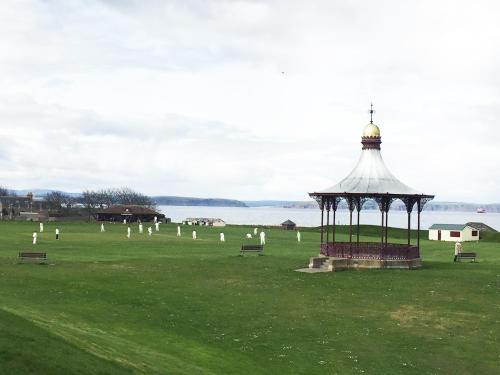 a gazebo in a field next to a body of water at Washington House in Nairn
