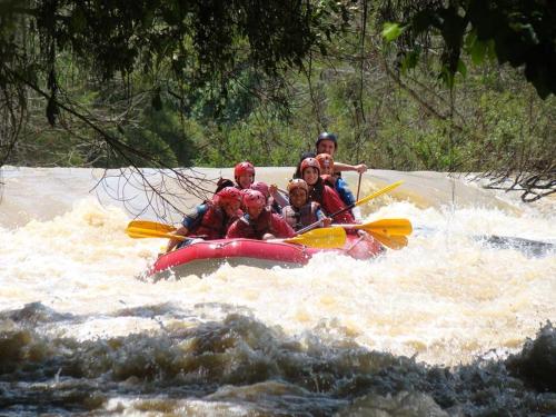 a group of people on a raft in a river at Blue Hill Hotel in Timbó