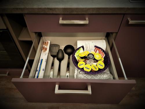 a drawer with utensils and a plate in it at Golden Key Apartments in Liberec