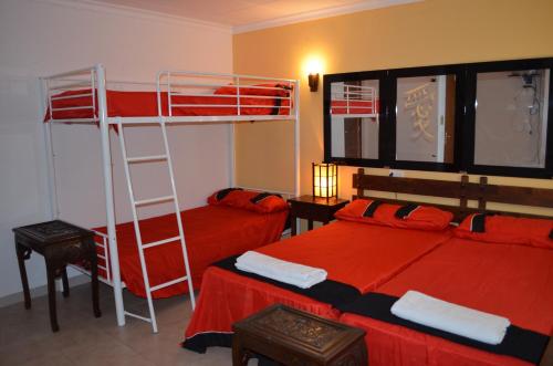a bedroom with two beds and a ladder at Residencia Santiago Mallorca in Cala Figuera