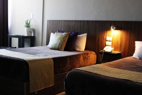 Una cama o camas en una habitación de Hotel FG