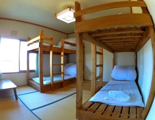 Postel nebo postele na pokoji v ubytování Rishiri Greenhill Inn