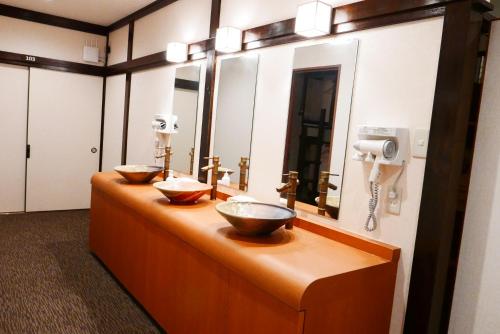 
a room with a sink and a mirror at K's House Fuji View - Travelers Hostel in Fujikawaguchiko

