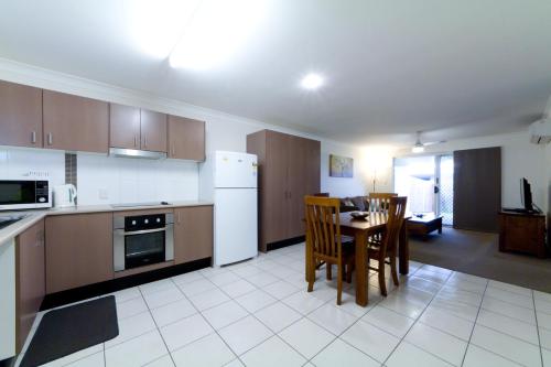 a kitchen and dining room with a table and chairs at Rockhampton Serviced Apartments in Rockhampton