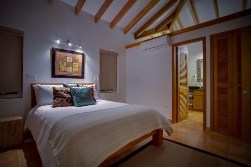 a bedroom with a large bed in a room at Naïa Resort and Spa in Placencia Village
