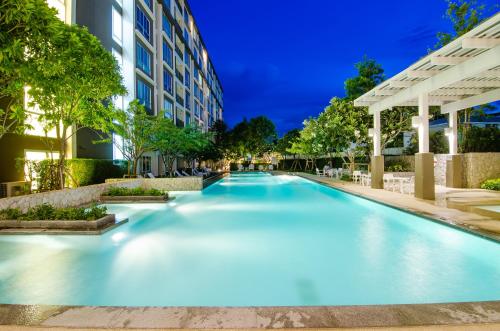a swimming pool in front of a building at Baan Peang Ploen in Hua Hin