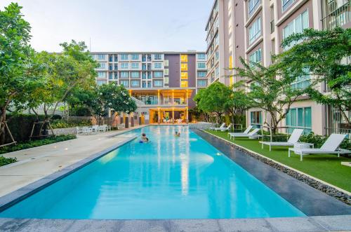 a swimming pool in front of a building at Baan Peang Ploen in Hua Hin