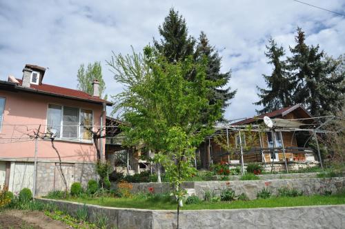 a house with a tree in front of it at Holiday Home Vilata in Kŭrdzhali