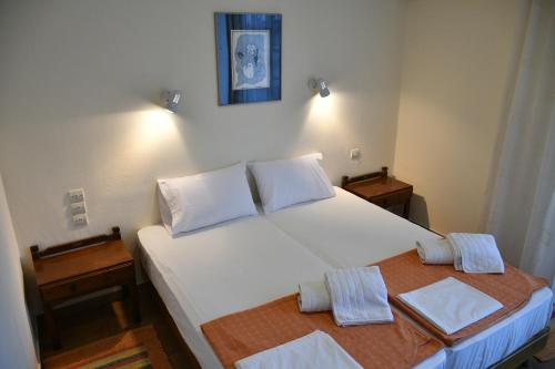 Ένα ή περισσότερα κρεβάτια σε δωμάτιο στο Ξενοδοχείο Ηρακλής