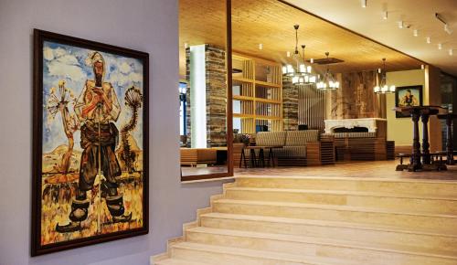 a painting on the wall of a lobby with stairs at Hot Springs Medical and SPA in Banya