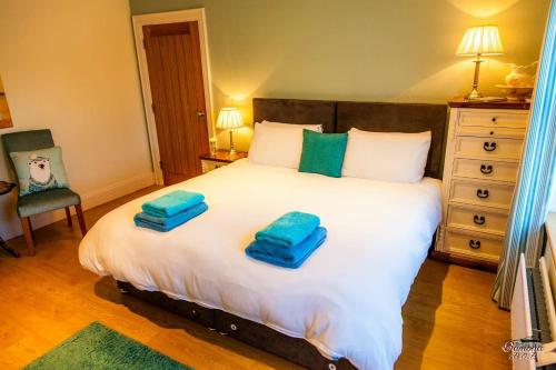 a bedroom with a bed with two towels on it at Samona in Kilkeel