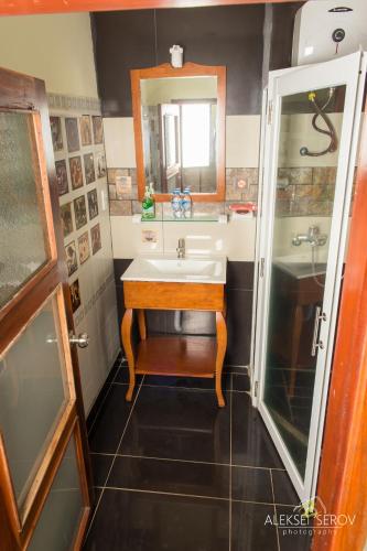 a bathroom with a sink and a mirror at Joe's Cafe & Garden Resort in Mui Ne