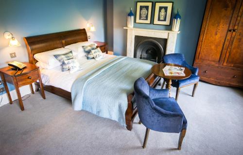 a bedroom with a bed and a table and chairs at Eslington Villa in Gateshead