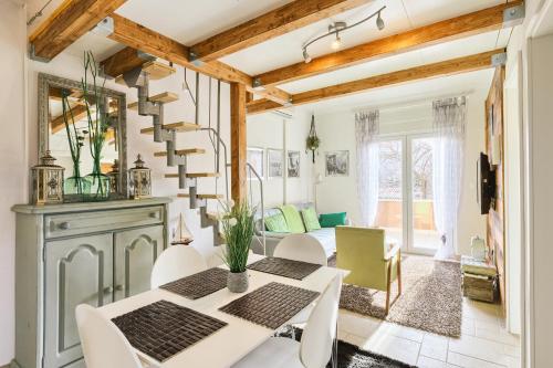 a dining room with a white table and chairs at Villa Marizella in Premantura