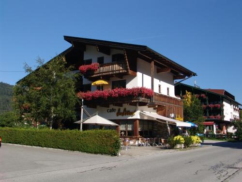 a building with flowers on the side of it at Das Landhaus am See in Achenkirch