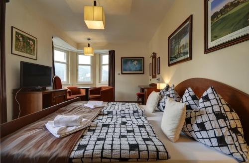 a bedroom with a large bed in a room at Pension Villa Miluška in Špindlerův Mlýn