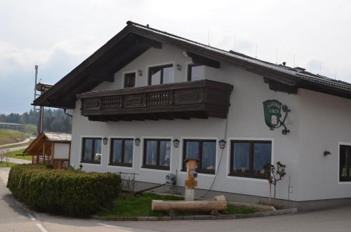 a white building with a balcony on top of it at Gasthof-Pension Urzn in Altmünster