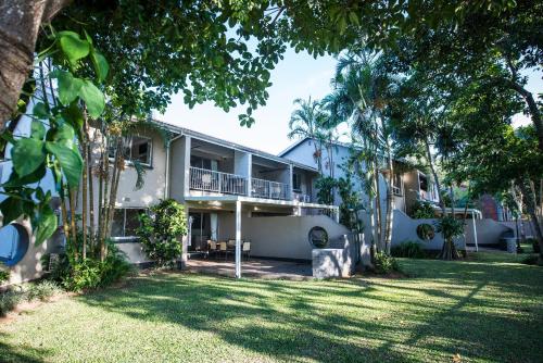 an exterior view of a building with a yard at First Group Lake View Cabanas in St Lucia