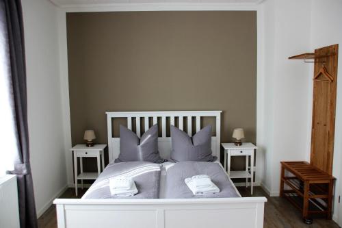 um quarto com uma cama branca e 2 mesas de cabeceira em Haus im Donautal em Beuron