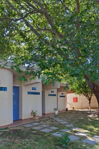 a row of buildings with blue and white doors at Long Beach Hotel & Resort in Lóngos
