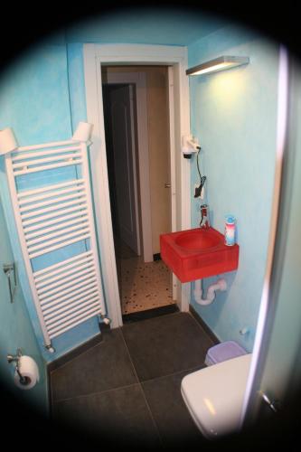 a bathroom with a red sink and a toilet at Due Papi in Savona