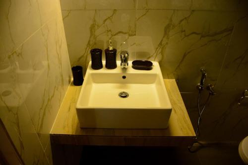 a white sink in a bathroom with a shower at Mama Beach Villa in Negombo