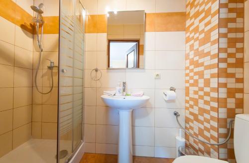 a bathroom with a sink and a shower and a toilet at Willa Zacisze in Ustroń
