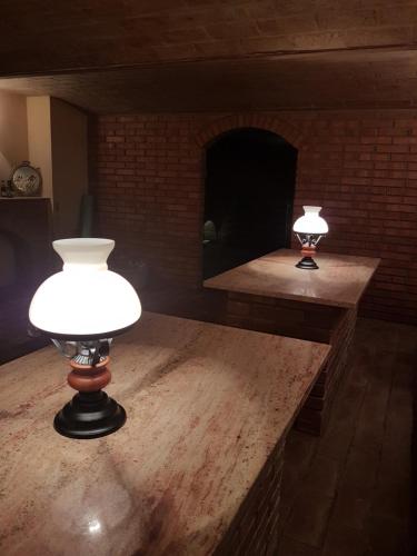 two lights on a table in a room with a fireplace at Pension Sunset Mezirolí in Nová Role