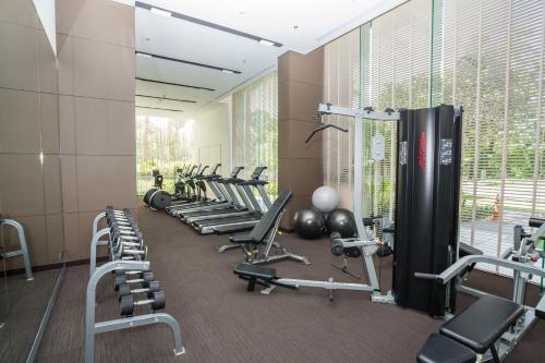 a gym with a row of exercise bikes and weights at Unixx by 4Poolvillas in Pattaya South