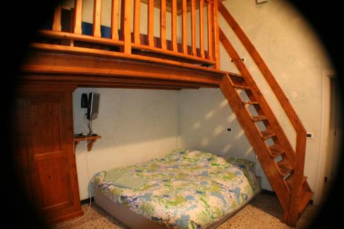 a bedroom with a bunk bed and a wooden staircase at Due Papi in Savona
