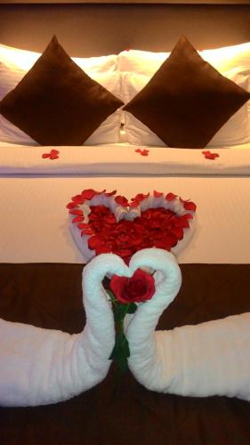 two swans making a heart on a bed at The Central Residency in Trivandrum