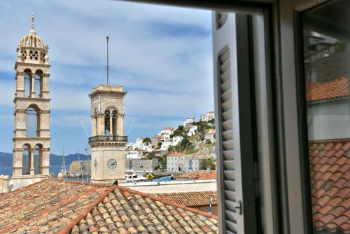 a view from a window of a city with two towers at Douskos Guesthouse in Hydra
